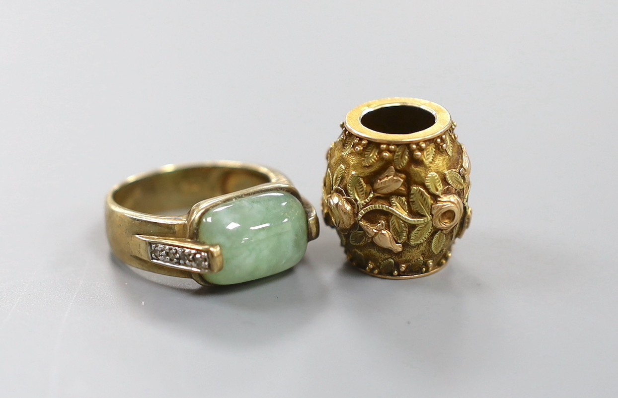 A 9ct gold and cabochon green stone and diamond chip5.6 grams set ring, size O, gross and a Victorian two colour yellow metal barrel pendant charm, 16mm, 3.1 grams.